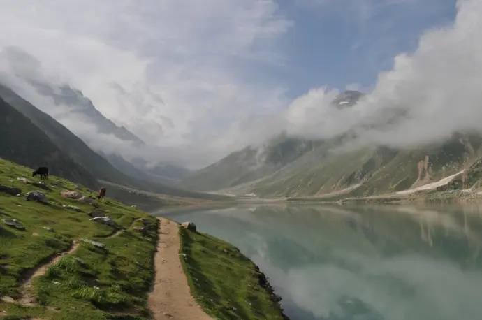 a mountain lake surrounded by a lush green hillside